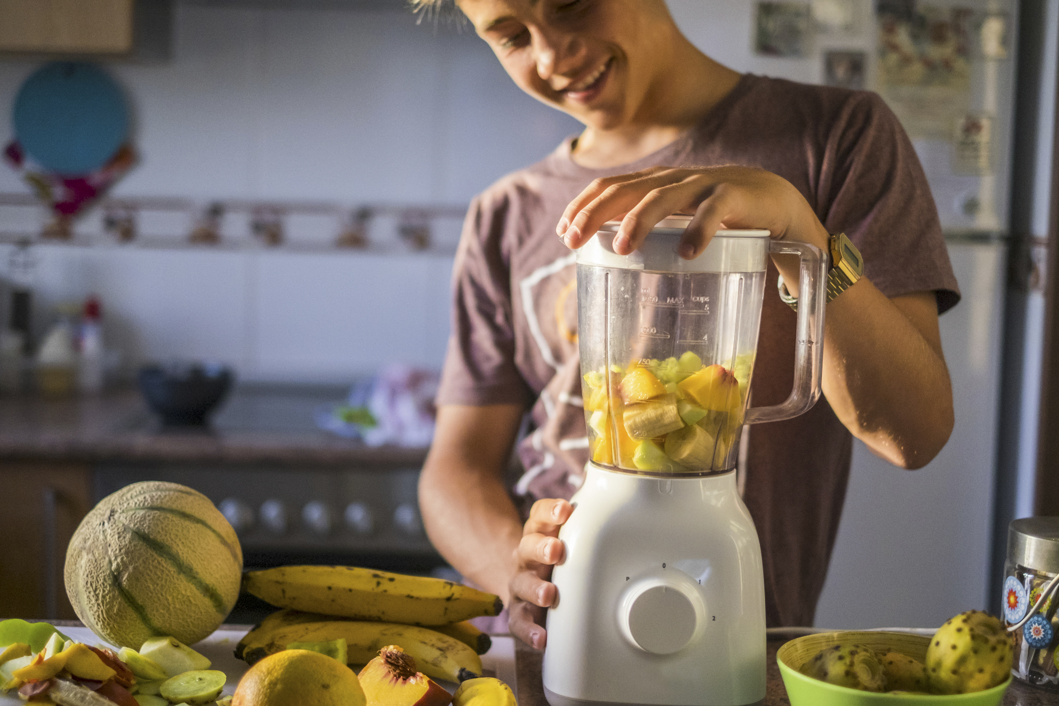 Male Teen Athlete Preparing Smoothie Before Workout