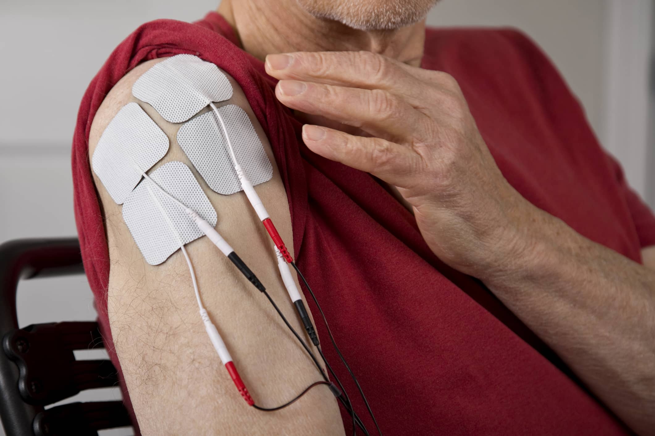 TENS Electrodes On Man's Shoulder