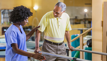 senior with physical therapist