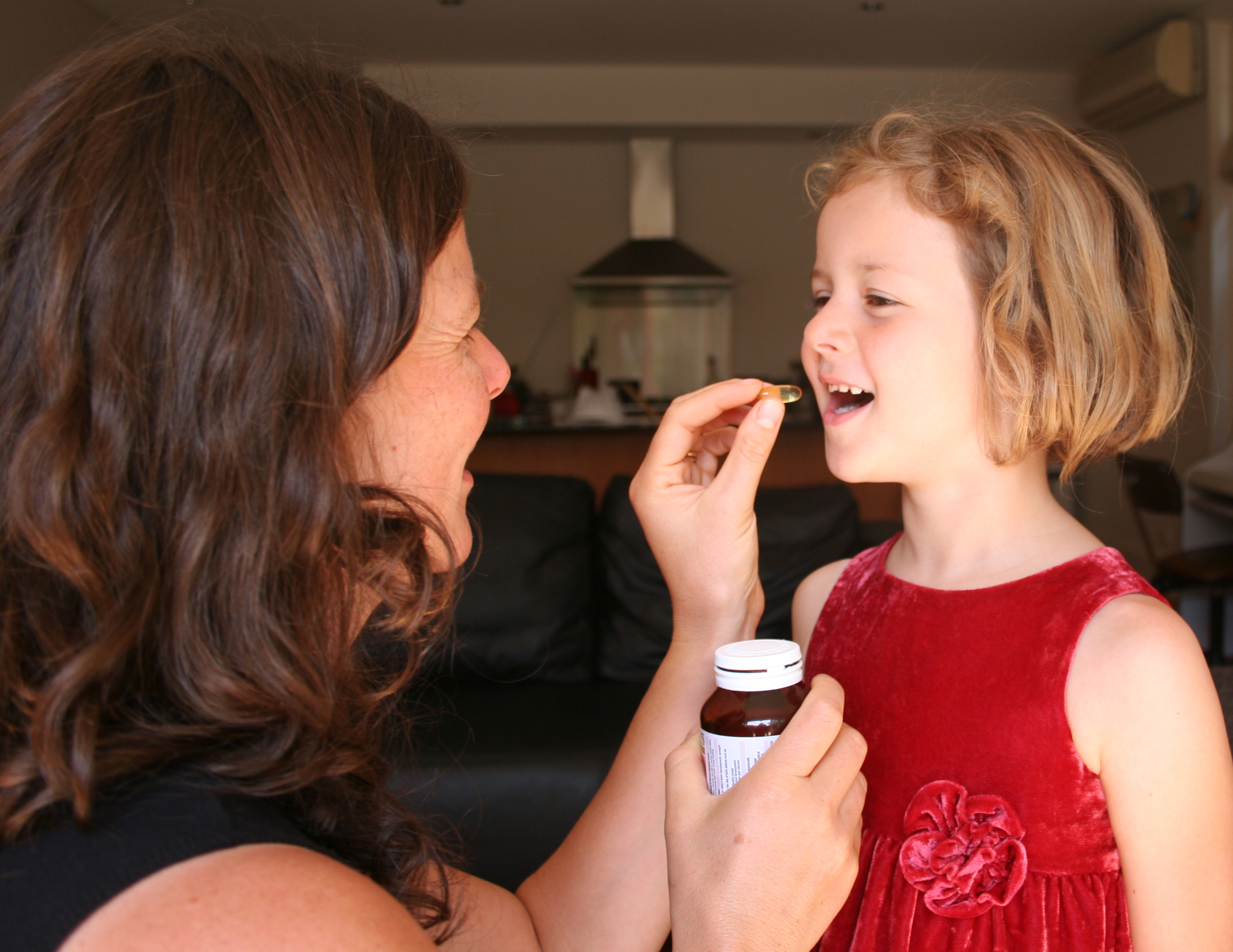 Child taking vitamin D supplement